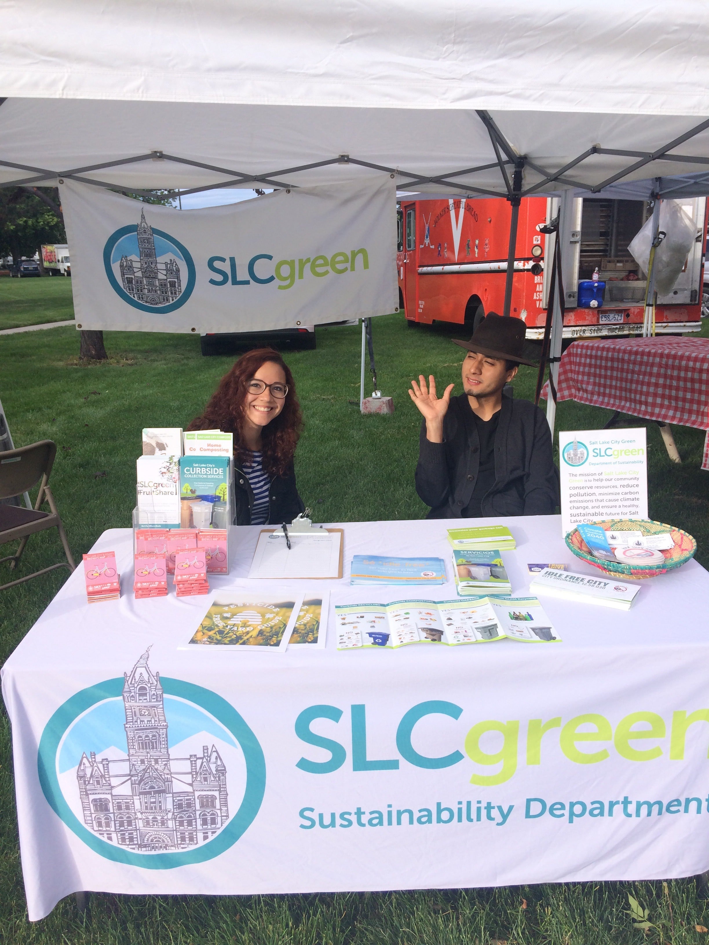 SLCgreen Interns Linda Derhak and Atticus Olmedo tabling at the Downtown Farmers Market.