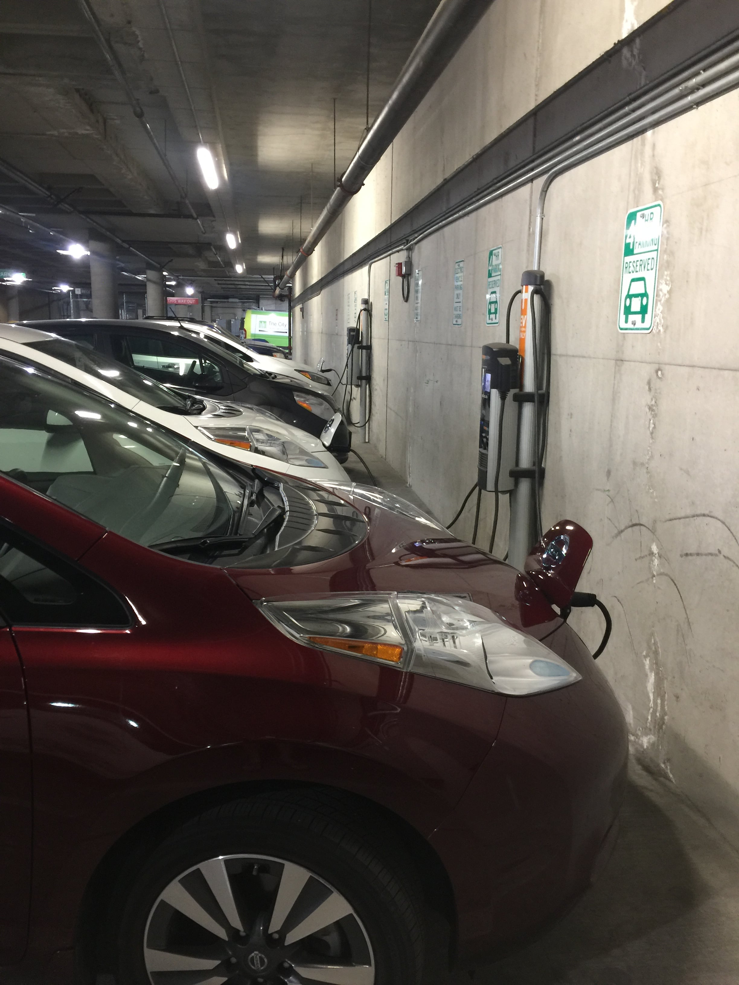 Electric vehicles charging at Downtown Library station.