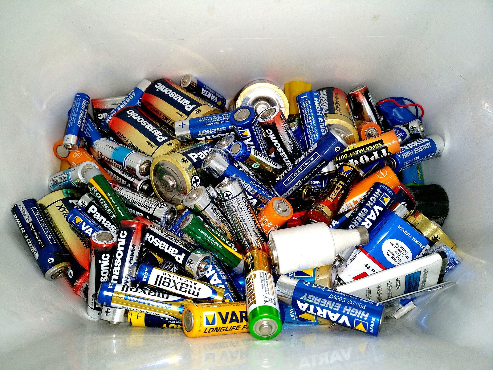 Photo of bucket of batteries of different varieties waiting appropriate disposal.