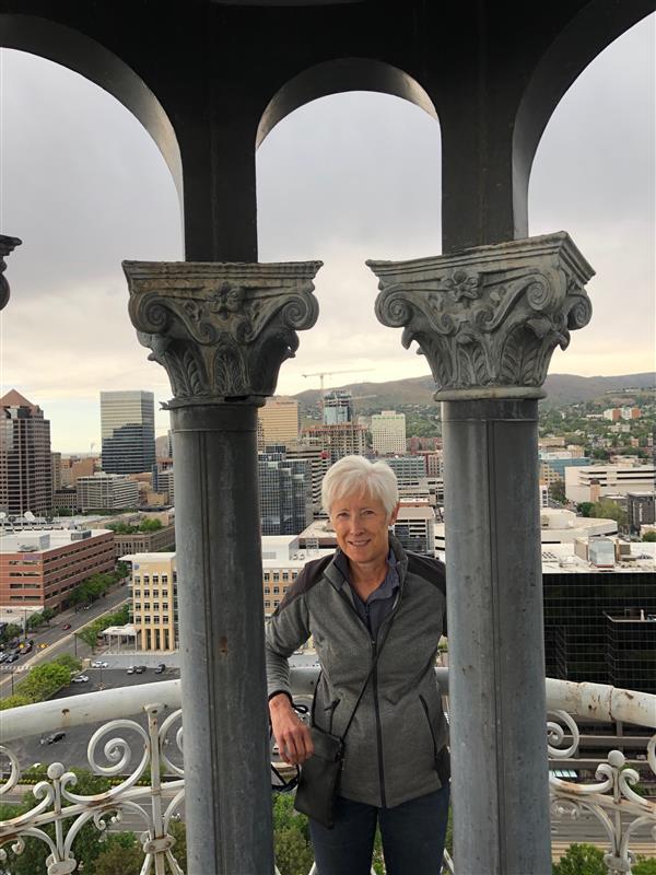 Photo of Vicki at the top of the City & County Building overlooking the down town area. 
