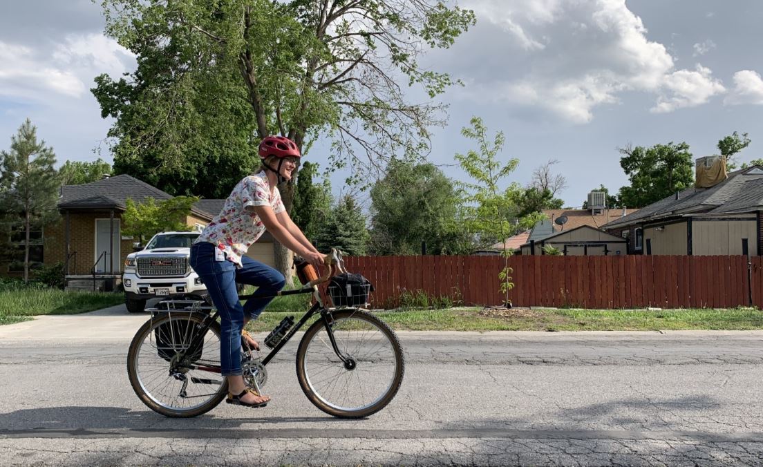 Woman riding her bike home from work.
